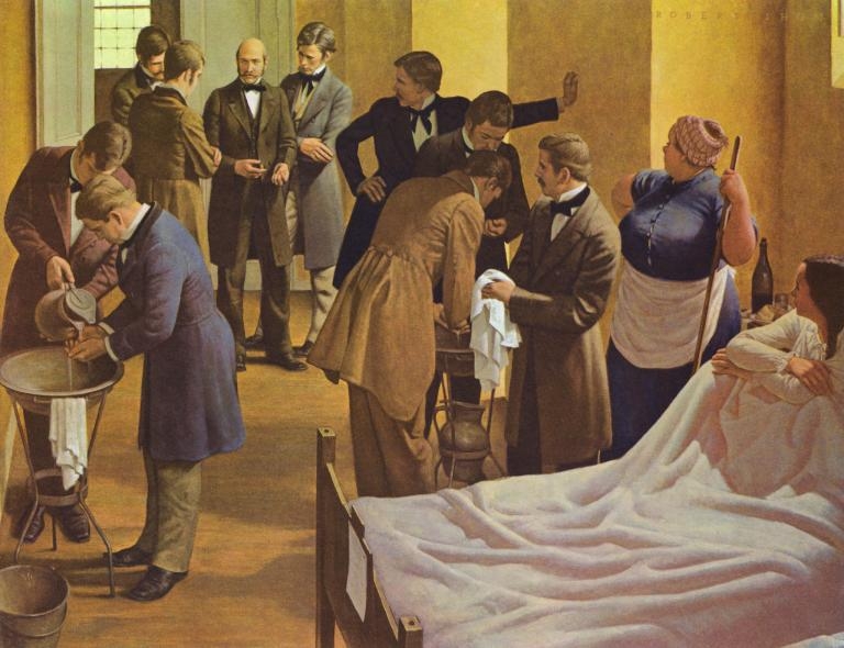 畫家羅伯特．托姆（Robert Thom）的作品，描繪塞默維斯（圖中央）在奧地利的維也納綜合醫院裡監督醫生，要求他們在為產科病人檢查前先洗手。PHOTOGRAPH BY GL ARCHIVE, ALAMY 