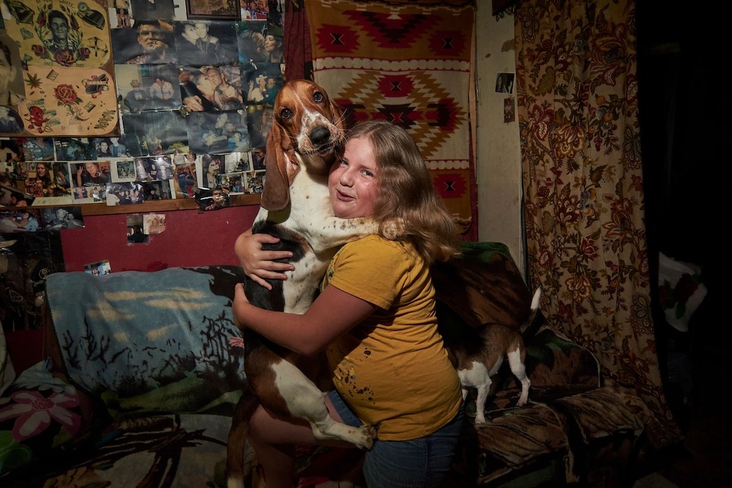 西維吉尼亞州布恩郡的一名女孩與她的狗。 PHOTOGRAPH BY STACY KRANITZ 