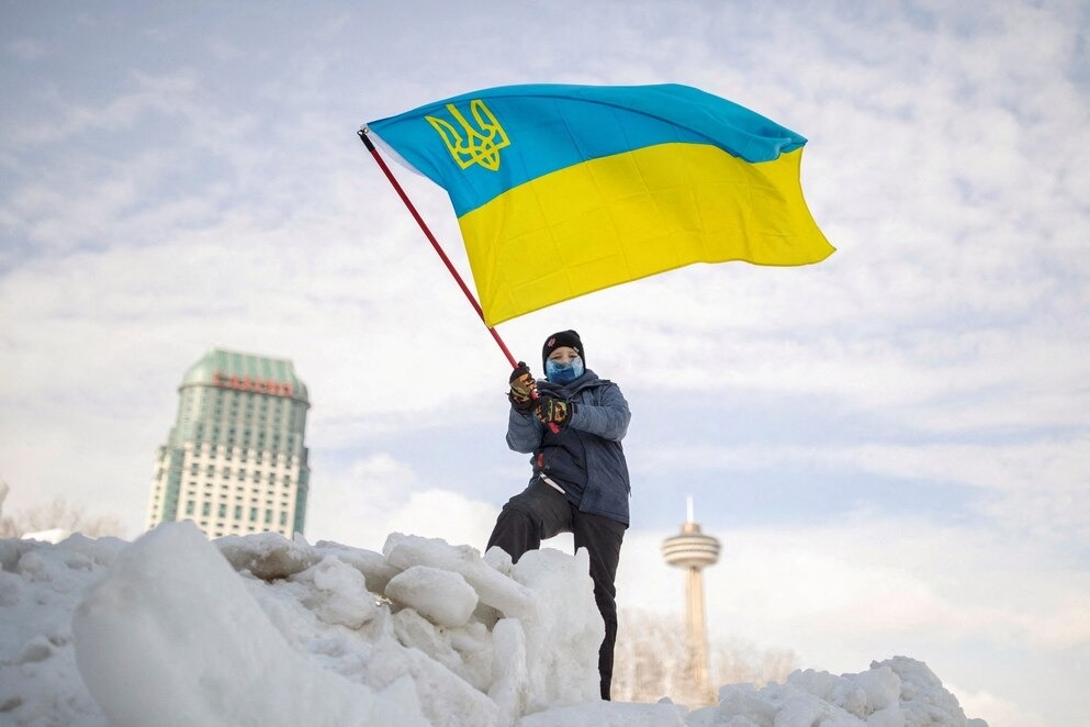 2022年初，俄羅斯入侵烏克蘭的威脅漸增，世界各地都有小型示威抗議活動為和平請願。此處是1月底時，一名男孩在加拿大尼加拉瀑布的集會上揮舞著烏克蘭國旗。PHOTOGRAPH BY NICK IWANYSHYN, REUTERS