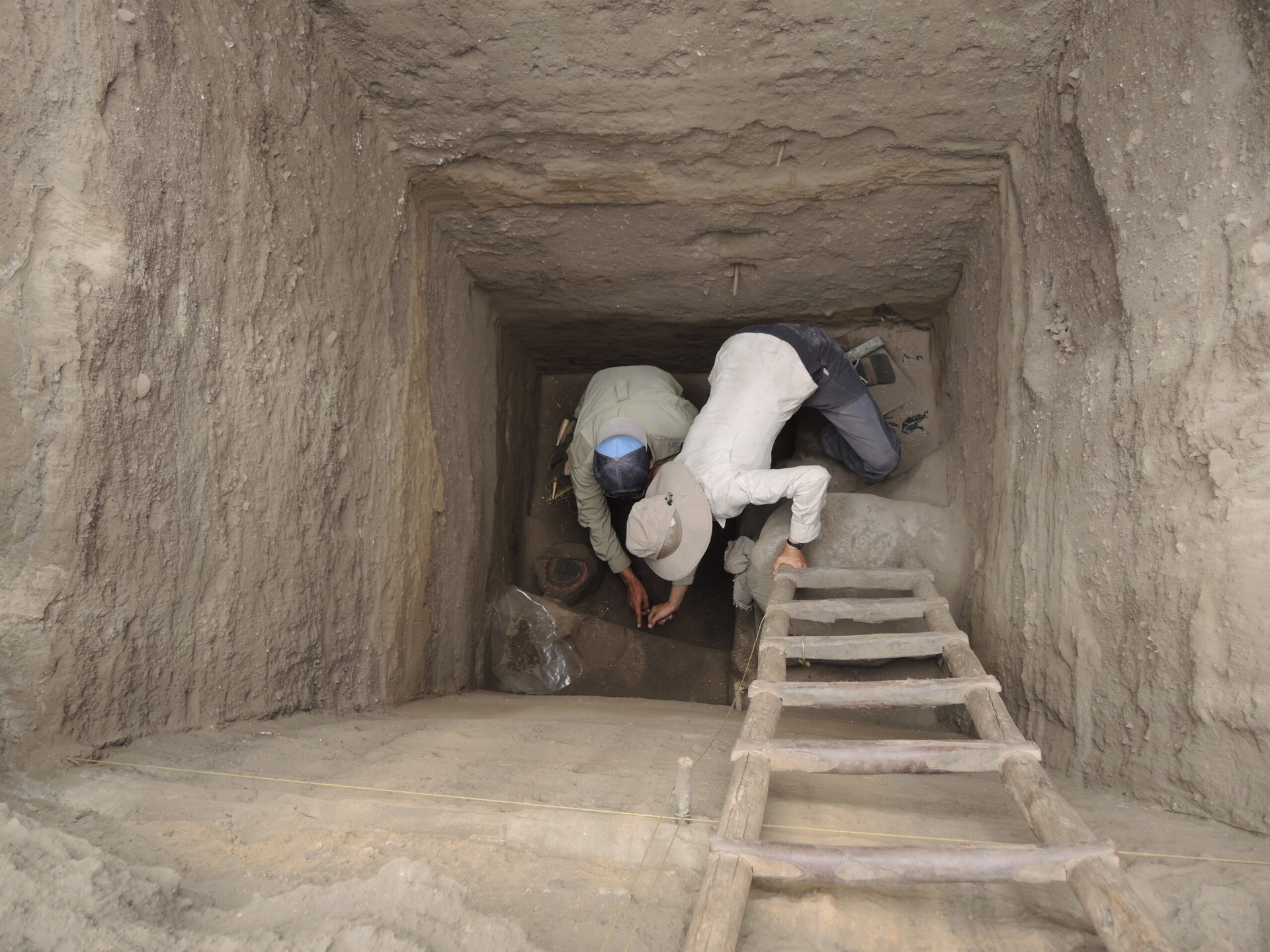 考古學家在深達 5 公尺的探坑內工作。 圖｜陳珮瑜 
